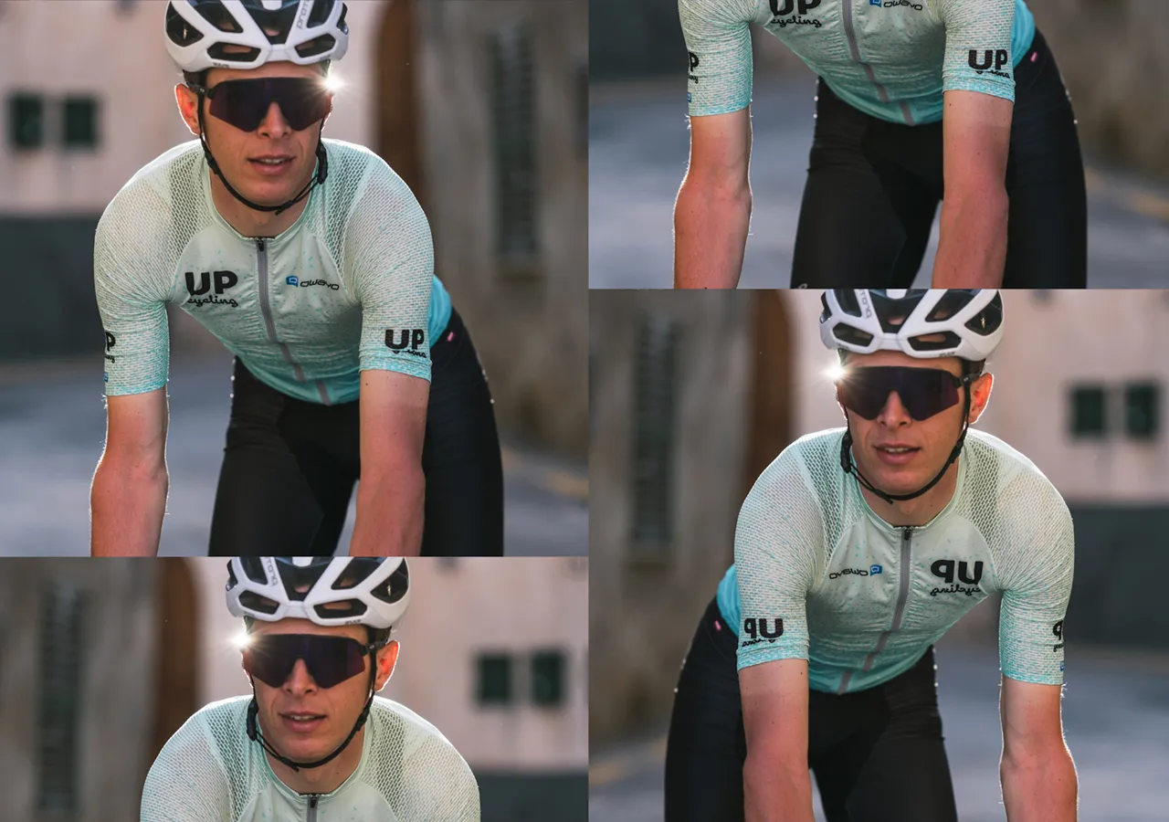 Ein Radfahrer in einem hellblauen, gemusterten Trikot mit dem Logo 'UP cycling' und dem Markennamen 'owayo' auf der Brust, der auf einem Fahrrad fährt.